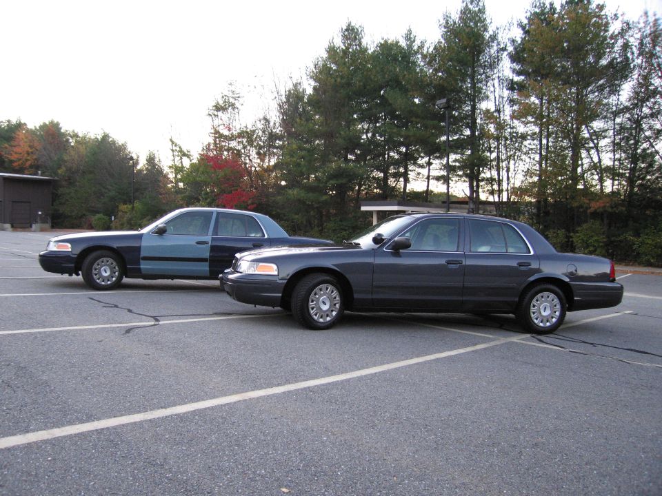 Two Ford Crown Victoria sedans parked together