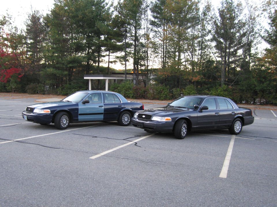 Two Ford Crown Victoria sedans parked at angles