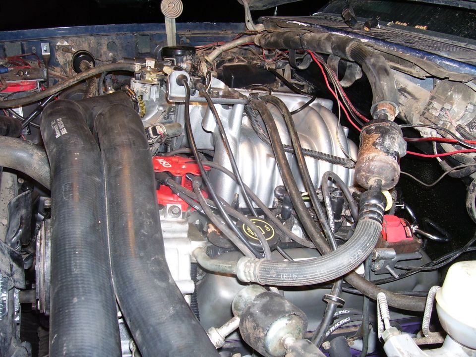 1991 Ford Bronco engine bay with V8 engine, intake manifold, and red MSD ignition parts.