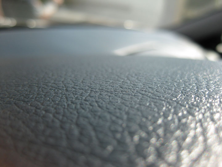 Close-up of a textured dashboard in a car.