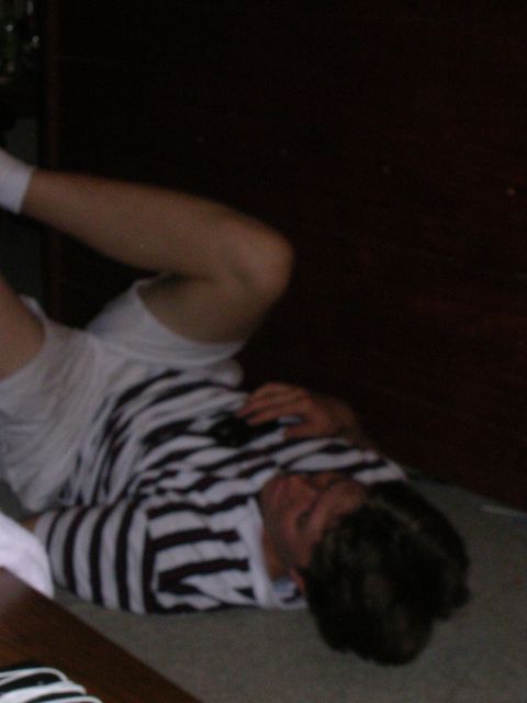 1983 Ford F-250 - A person is lying on the floor wearing a striped shirt and white shorts.