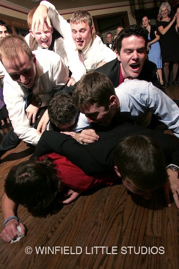 1983 Ford F-250 - A group of men are wrestling on a wooden floor at an event.