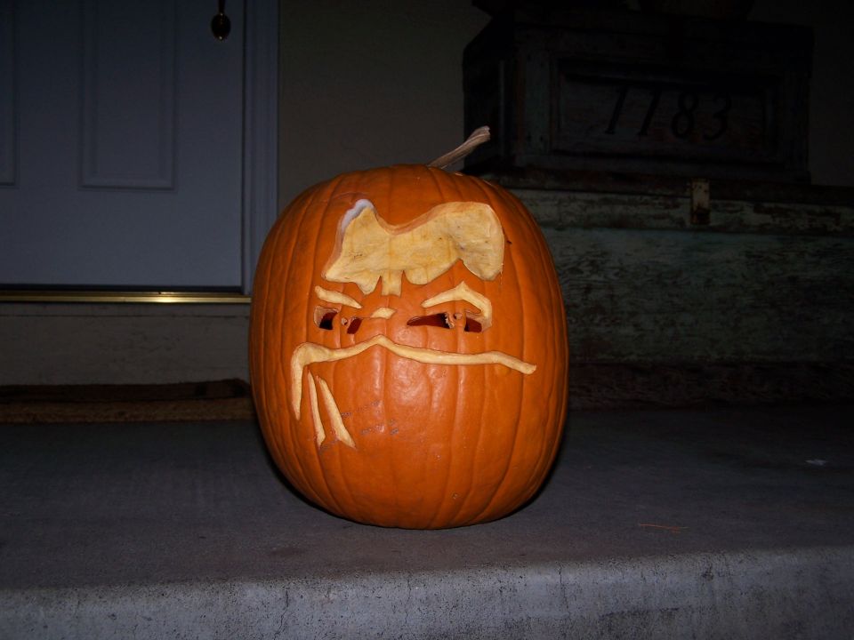 Carved pumpkin with a face on a porch step