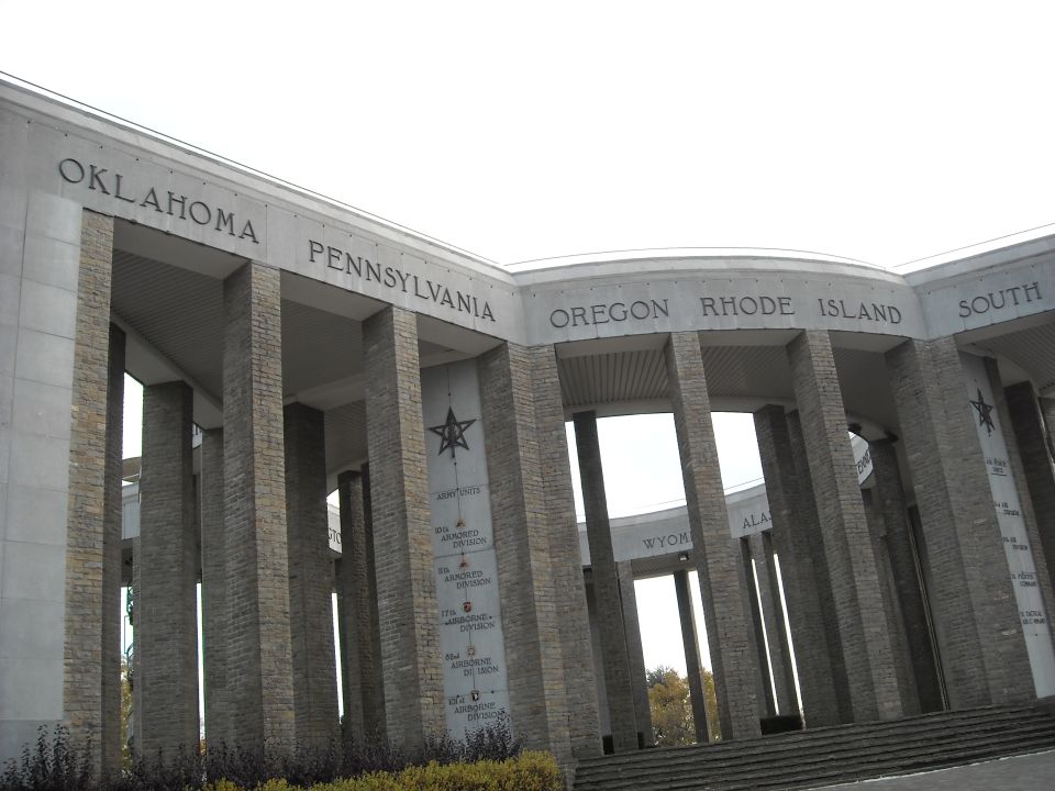 Stone monument with inscribed state names like Oklahoma and Pennsylvania, and military division details