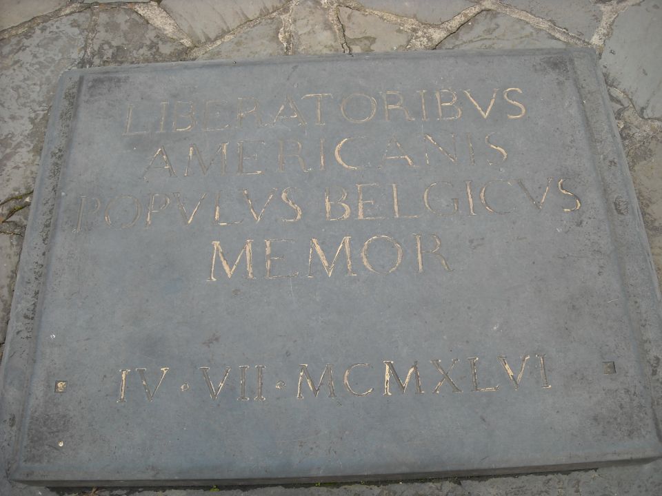 Stone memorial plaque with Latin inscription to American liberators