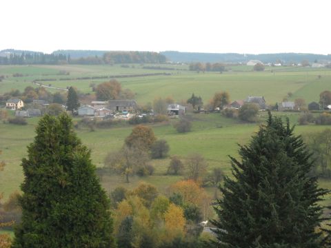 1979 Ford F-150 - A wide view of a rural landscape farm buildings, rolling green fields, and trees displaying autumn foliage.