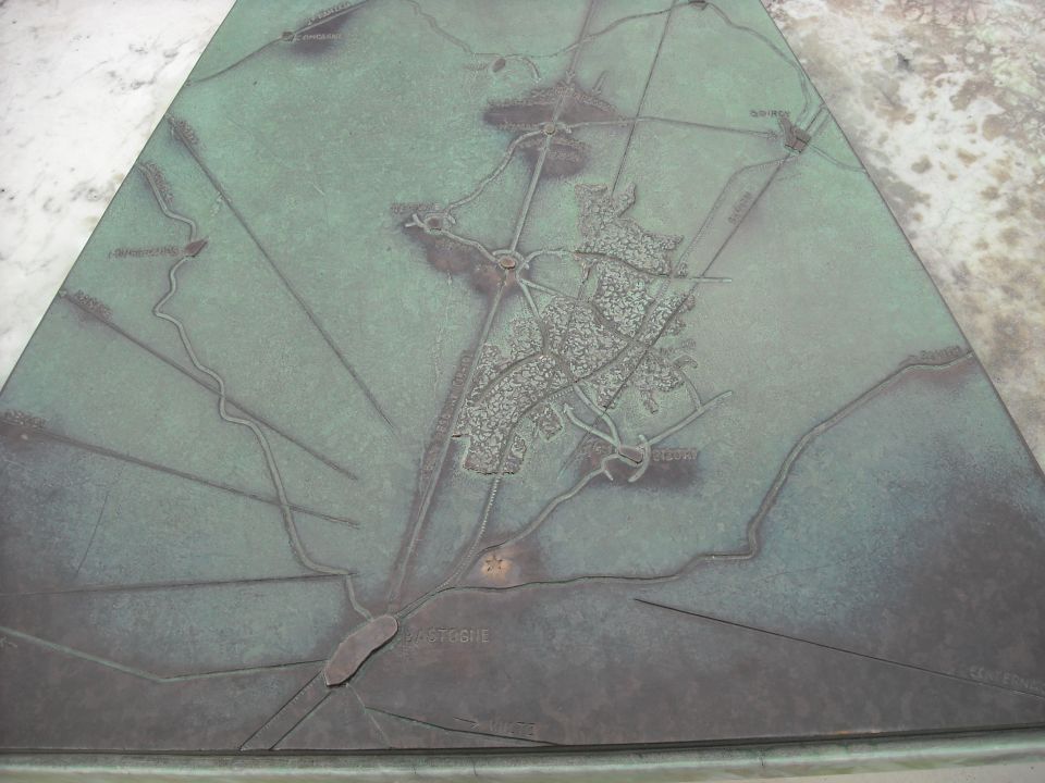 Photo of a bronze relief map monument showing the town of Bastogne
