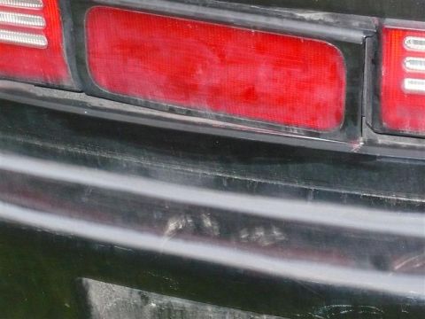 1993 Ford Probe - This photo shows a close-up view of a vehicle's rear, focusing on the taillight and bumper area. The Supermotors.net logo is visible in the…