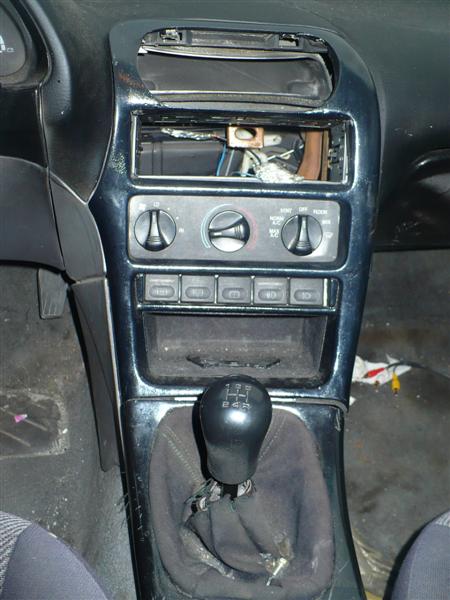 1993 Ford Probe - The interior of a 1993 Ford Probe shows a manual transmission and a dashboard with missing components.