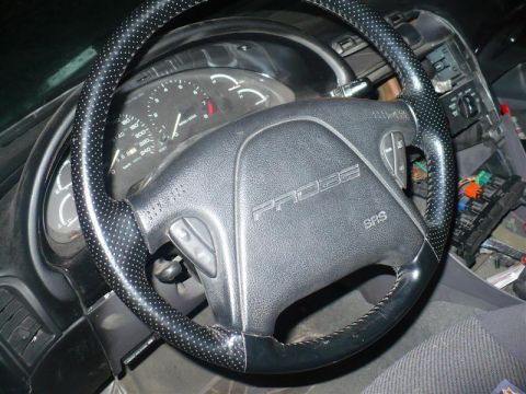 1993 Ford Probe - The interior of a car shows the steering wheel and dashboard, with the word 'PROBE' clearly visible on the steering wheel.