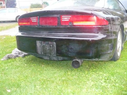 1993 Ford Probe - Rear view of a black 1993 Ford Probe, showing the bumper, taillights, and exhaust.