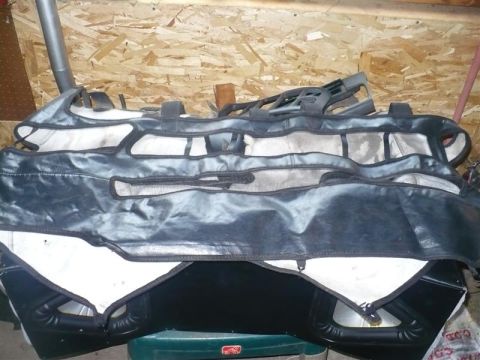 1993 Ford Probe - Car seat covers are piled up, showing their black exterior and white interior lining.