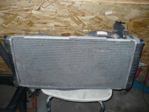 1993 Ford Probe - A car radiator assembly, likely removed from a vehicle, is shown in a workshop setting.