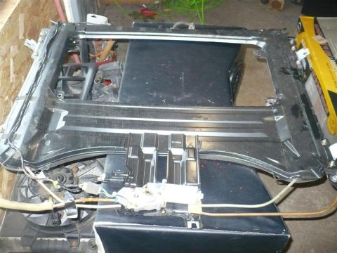 1993 Ford Probe - A disassembled sunroof assembly is shown, with visible motor and wiring components.