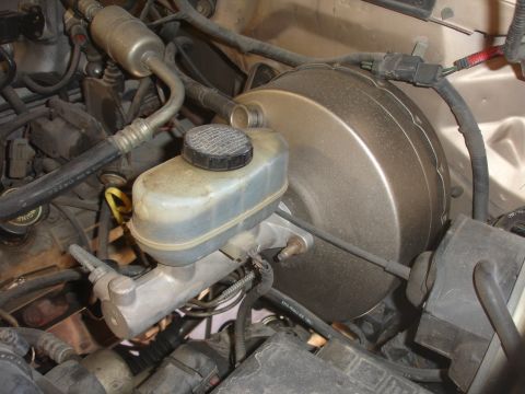 1992 Ford F-350 - The master cylinder and brake booster are key components of a vehicle's braking system.