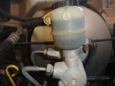 1992 Ford F-350 - Close-up view of a vehicle's master cylinder and brake fluid reservoir.