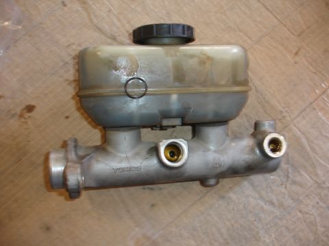 1992 Ford F-350 - A brake master cylinder part is shown with a plastic reservoir and metal body, 'TOKICO' text.