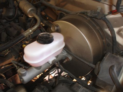 1992 Ford F-350 - Close-up view of the master cylinder and brake booster assembly, a critical component of the braking system.