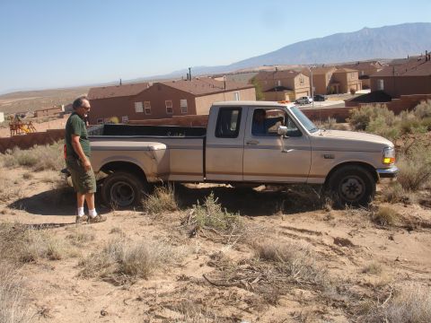 1992 Ford F-350 - A 1992 Ford F-350 is parked on a dirt path with a man standing next to it.