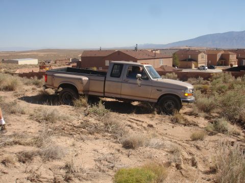 1992 Ford F-350 - This Ford F-350 is shown off-road with a residential area in the background.