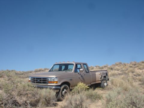 1992 Ford F-350 - This 1992 Ford F-350 pickup truck is seen parked in a dry, brushy area with a clear blue sky above.