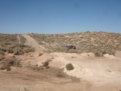 1992 Ford F-350 - A silver 1992 Ford F-350 pickup truck is seen off-road in a dry, brush-covered landscape under a clear blue sky.