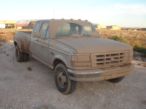 1992 Ford F-350 - This dusty Ford F-350 dually truck is covered in dirt, suggesting it has been off-road.