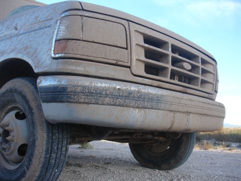 1992 Ford F-350 - Front view of a heavily mud-splattered 1992 Ford F-350, showing its grille and bumper.
