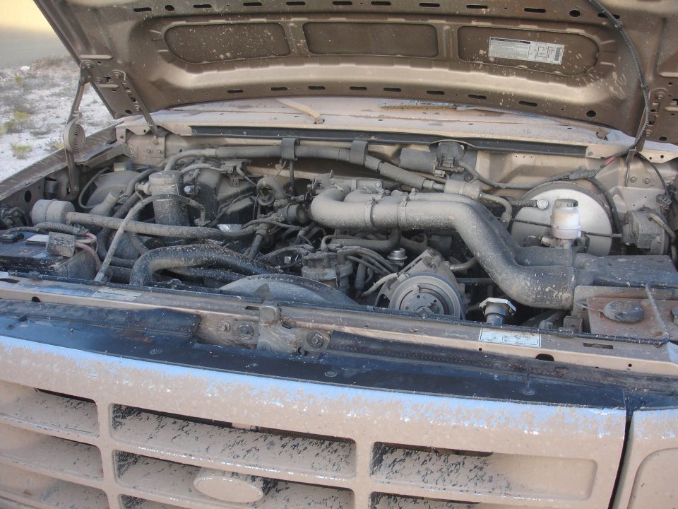 1992 Ford F-350 engine bay, covered in dust, with hood open