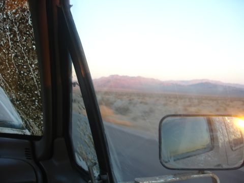 1992 Ford F-350 - Driving through a desert landscape at sunrise, seen from the driver's perspective.