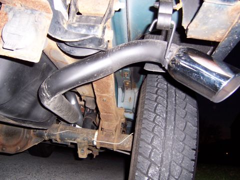 1995 Ford Bronco - Close-up view of the rear tire and exhaust system of a vehicle.
