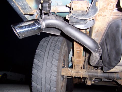 1995 Ford Bronco - Close-up view of a vehicle's exhaust pipe and tire.