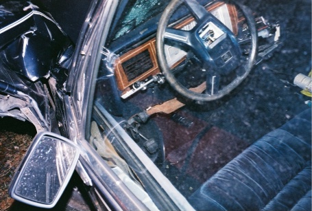 1988 Mercury Grand Marquis - The interior of a 1988 Mercury Grand Marquis shows significant damage to the driver's side after an accident.