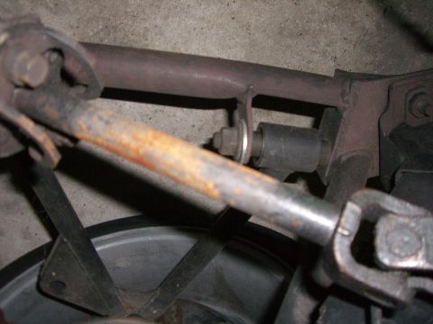 1988 Ford Bronco - Close-up view of vehicle driveshaft and suspension components, showing rust and wear.