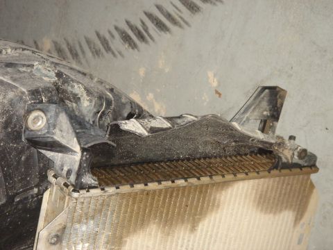 1996 Ford Bronco - Radiator with damaged black plastic mounting bracket.