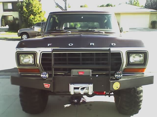 Front view of brown Ford truck with FORD hood lettering, winch and PIAA lights