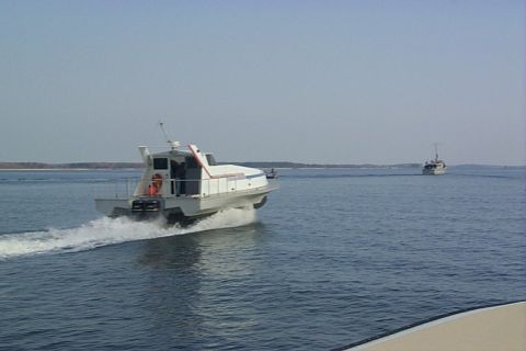 1978 Ford F-250 - Two boats navigate the water under a clear sky.