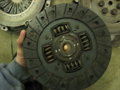 1995 Mitsubishi Eclipse - Close-up of a clutch disc and pressure plate assembly, likely for a manual transmission.