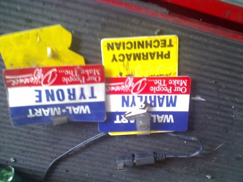 1971 Ford Bronco - Walmart name tags and a pharmacy technician tag are visible on a dark surface.