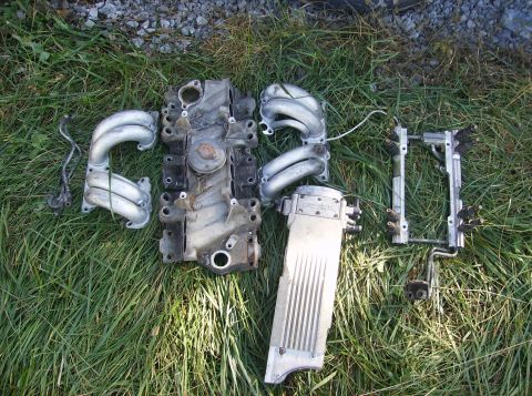 1995 Ford Probe - Engine parts are spread out on the grass, with a watermark for SuperMotors.net visible.
