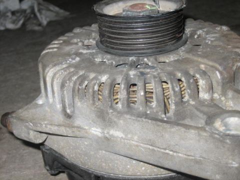 1996 Ford Thunderbird - This is a close-up view of a car's alternator, a crucial component for the vehicle's electrical system.
