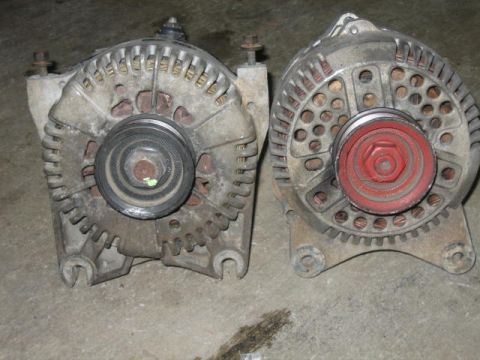 1996 Ford Thunderbird - Two automotive alternators are shown, one with a black pulley and the other with a red pulley. The registry information for this image is l…
