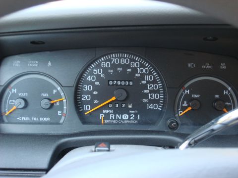 2003 Ford Crown Victoria - The dashboard displays the odometer reading and various other gauges including fuel, volts, temperature, and oil levels.