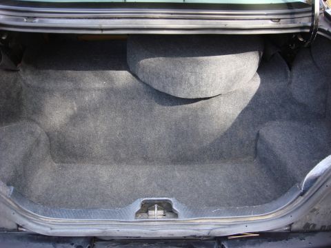 2003 Ford Crown Victoria - Trunk interior of a 2003 Ford Crown Victoria, showing the spare tire well.