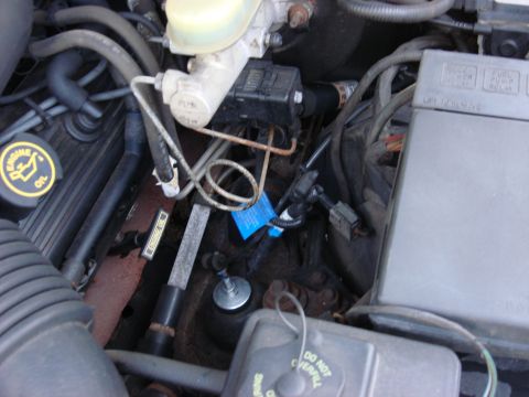2003 Ford Crown Victoria - Close-up of an engine bay, focusing on the brake fluid reservoir and surrounding components.