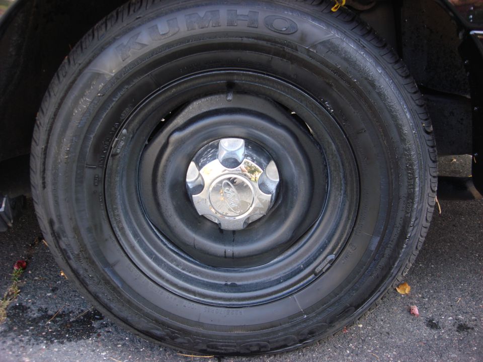 Wheel with Kumho tire and chrome hubcap