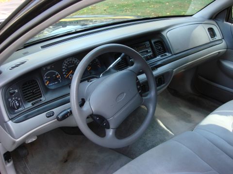 2003 Ford Crown Victoria - Interior view of a 2003 Ford Crown Victoria, the dashboard and steering wheel.