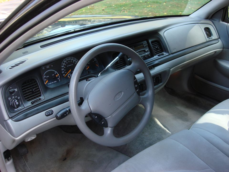 2003 Ford Crown Victoria interior showing dashboard, steering wheel, and seats