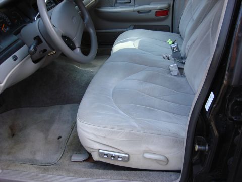 2003 Ford Crown Victoria - Interior view of a 2003 Ford Crown Victoria, showing the front passenger seat and dashboard area.