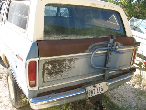 1979 Ford Bronco - This Ford Bronco shows rust and wear on its rear panel, with a visible license plate.